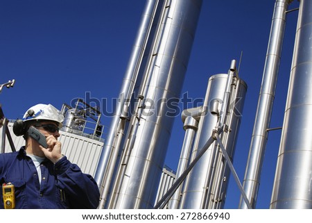 oil and gas engineer with large gas-pipes pipelines in the background