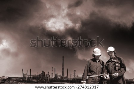 oil gas, fuel and industrial pollution, two workers in foreground, toning concept