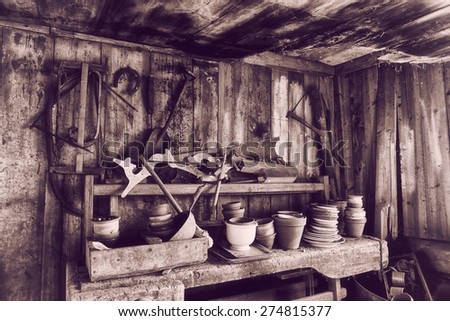 old barn 17th century with tools, pots and pans, vintage effect, analog effects