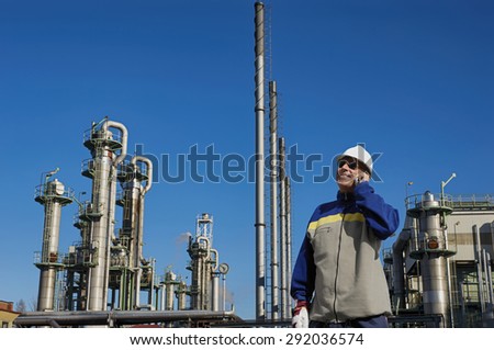 refinery worker with chemical industry in background