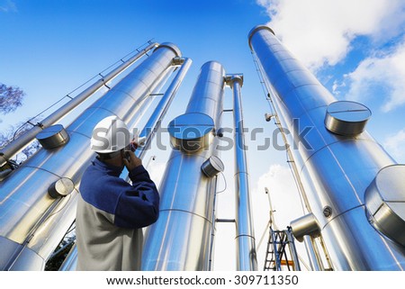 oil-worker, engineer with large oil and gas pipes, pipelines, slight HDR effects.