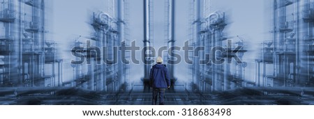 oil and gas worker with large refinery in background, zoom effect on the background