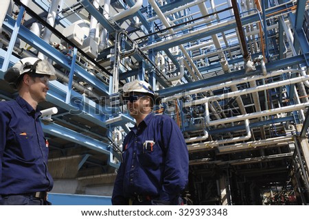 oil and gas workers inside pipelines constructions, refinery industry