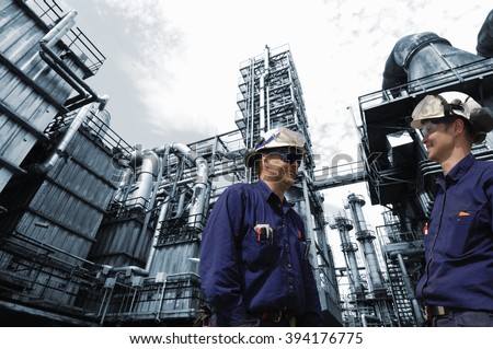 refinery workers in close-ups with large oil and gas industry in background