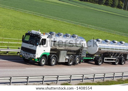 oil-tanker, truck on highway against green countryside