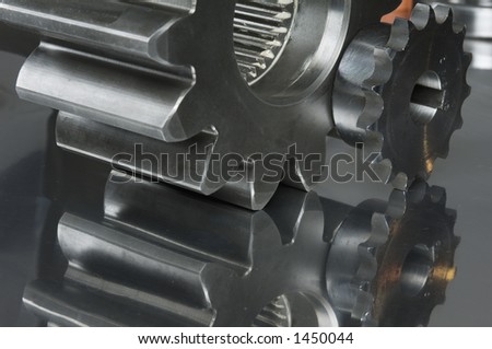 close-ups of gears with clear mirror-image in titanium