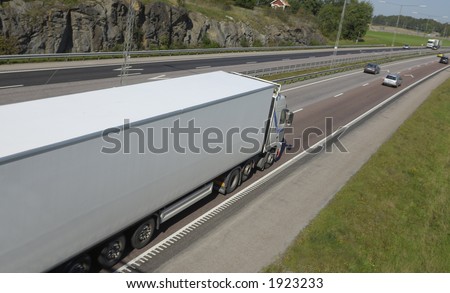 white truck, lorry on highway, leaning wide-view