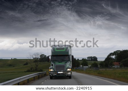 large lorry, truck driving at night in stormy dark weather