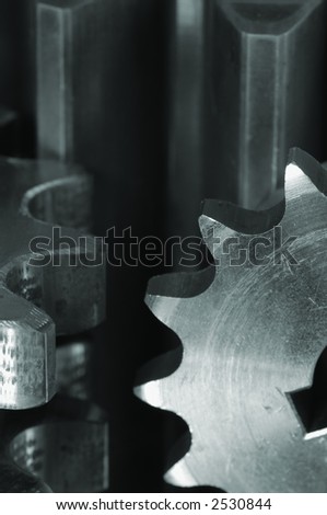 extreme details of gears, closest in focus, all in a greenish metallic cast