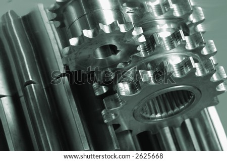 gears, pinions connecting in a greenish metallic tone
