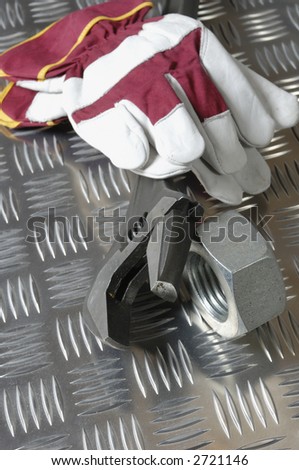 gloves, tools, wrench-idea against diamond-plate-steel, construction-industry