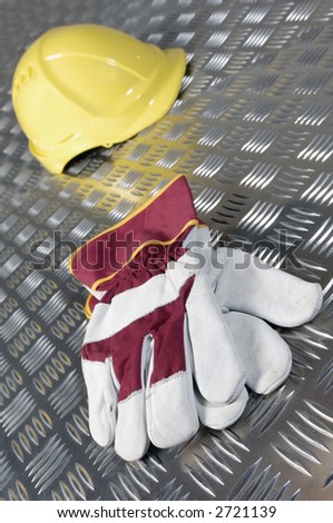 hard-hat and gloves-concept, lying on steel-plates, construction-industry