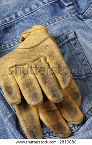 jeans, denim cloth with leather gloves in back-pocket