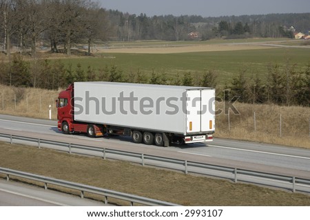 clean truck, side-view, driving on highway