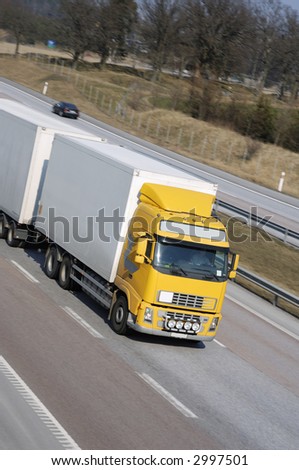 large clean truck driving on highway, close-up shot and tilted angle