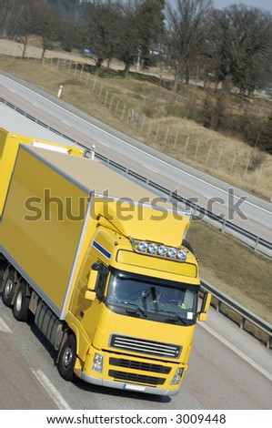 large yellow truck driving, elevated-view, close-up of cabin