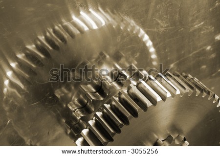 large industrial gears reflecting in steel, all in sepia toning