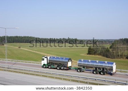 fuel truck on the go driving on highway with country-side