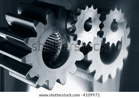 gears mechanical parts mirrored in steel and in a dark duplex greenish toning