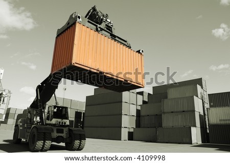forklift stacking containers in a dual color toning concept of metallic tone and orange