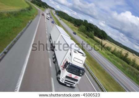 truck driving on highway, blurred part and countryside