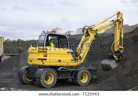 bulldozer, digger excavating earth and stone