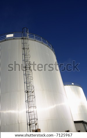 refinery oil tanks under blue sky and sunlight