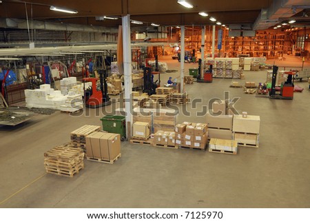 interior of warehouse with moving people, packages and parcels