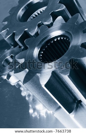 large industrial gear- machinery reflecting in steel and in bluish toning concept