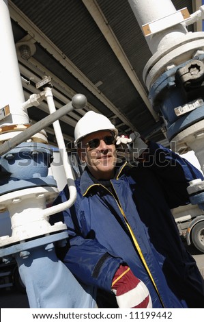 engineer, close-ups talking in phone inside oil and gas installations