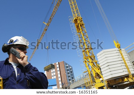 construction engineer in front of mobile crane inside building-site