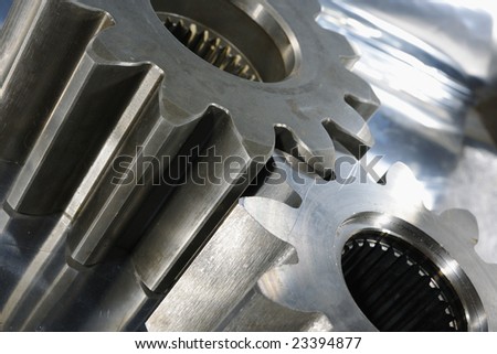 two large driving gears, aircraft-industry, against brushed aluminum background