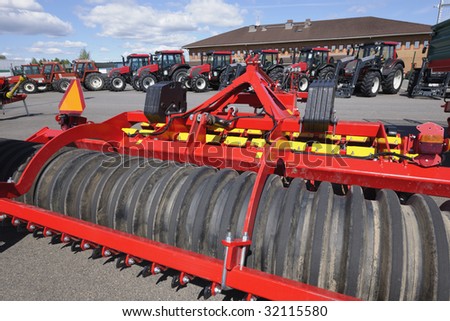 ploughs and tractors, latest models of farming-equipment, trademarks removed