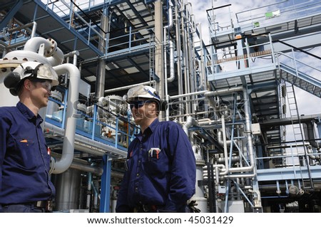 two engineers working inside oil and gas refinery