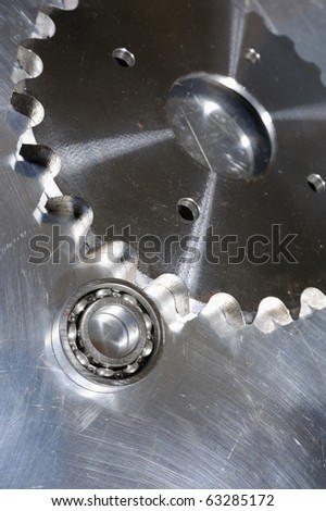 small ball-bearing and large industrial gear in blue toning idea