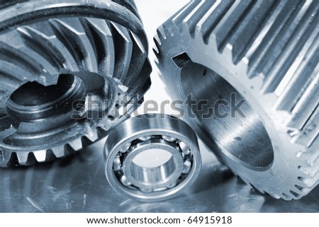 large industrial gears and ball-bearing in a metal blue toning idea