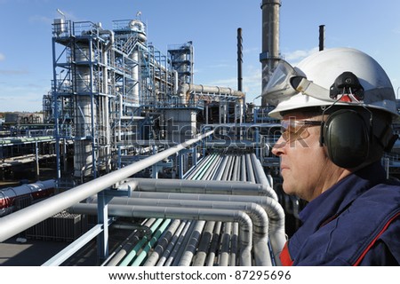 refinery worker with large petrochemical industry in background