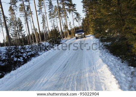 suv,car, driving on small snowy country-road, winter scenic from sweden