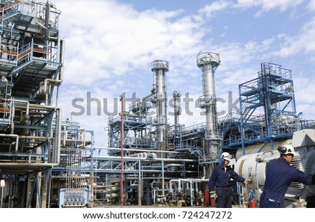 refinery workers with machinery inside large oil and gas industry