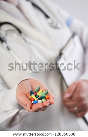 Doctor showing a handful of colorful pills