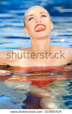 Laughing Woman With Her Head Thrown Back Relaxing In A Sparkling Blue