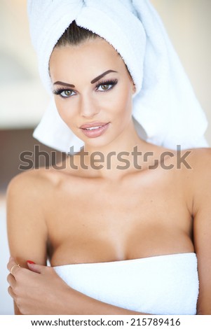 Portrait of Woman Wearing Make-Up and White Bath Towel with Hair Wrapped in Towel