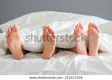 Close up Sweet Partners Soles on White Bed with Cover