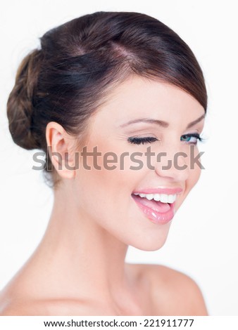 Close Up Portrait of Smiling Brunette Woman Winking in Studio
