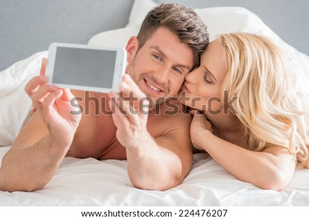 Close up Young Romantic Couple Capturing Romantic Moments at Bed.