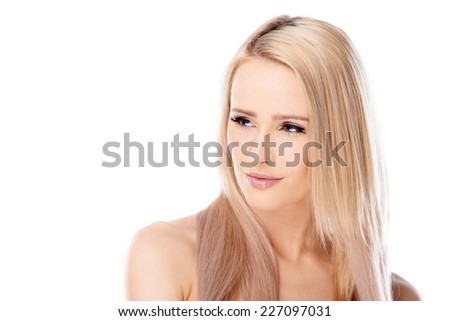Pretty blond woman with bare shoulders looking off to the side with a thoughtful serious expression  on white