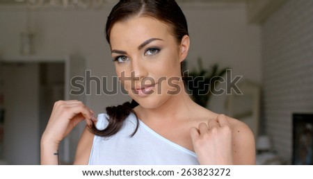 Close up Attractive Young Woman  Wearing Off Shoulder Outfit  Touching her Bare Shoulder While Looking at the Camera.