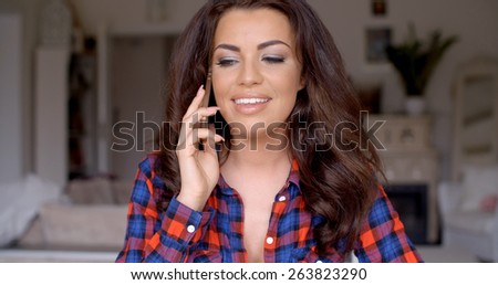 Close up Smiling Pretty Young Woman with Long Wavy Hair  Wearing Long Sleeves Shirt  Talking to Someone on Mobile Phone.