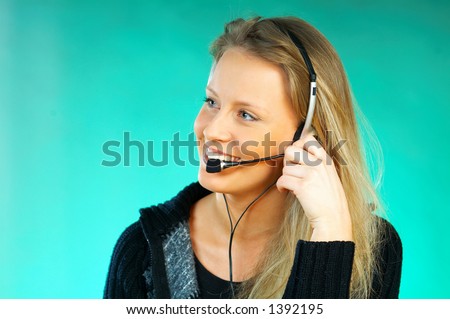Young pretty woman wearing a phone headset. Call Centre Agent