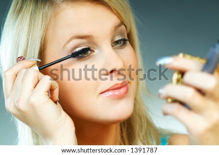 stock photo : Sexy blond young woman doing makeup